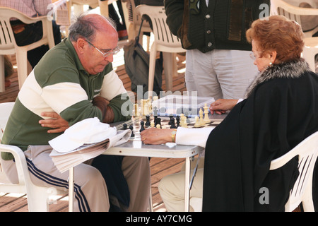 People playing chess on the beach in the sun in Benidorm. Stock Photo