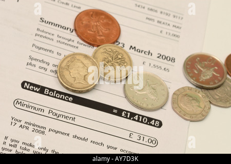 Credit card monthly statement bill baalnce and money coin cash showing minimum payment Stock Photo