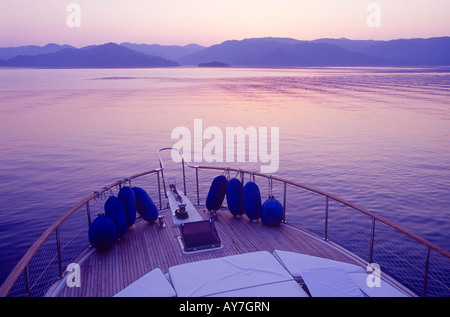 Sunset at Gocek seen from a motor yacht a popular Blue Cruise stop Bay of Fethiye Mugla Turkey Stock Photo