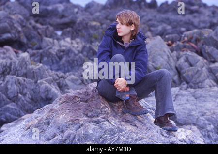 female Age 20 30 Sat on Rocks in Outdoor Activity Clothing Stock Photo