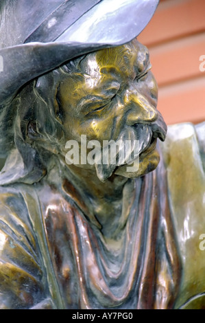 A bronze sculpture of a weathered cowboy stands in front of Sonya's Gallery, in the  mountain town of Ruidoso, New Mexico. Stock Photo