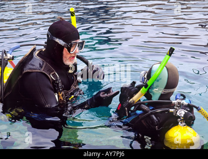 A diving instructor supervises a student during scuba school, at the Blue Hole in Santa Rosa, New Mexico. Stock Photo