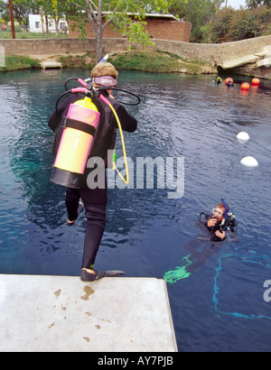 A diving instructor supervises a student during scuba school, at the Blue Hole in Santa Rosa, New Mexico. Stock Photo