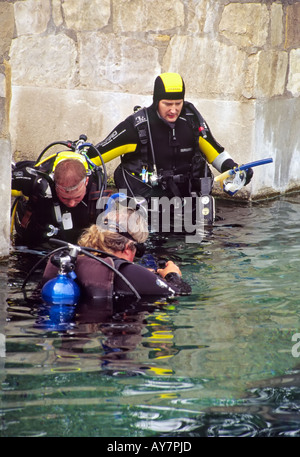 A diving instructor supervises students during scuba school, at the Blue Hole in Santa Rosa, New Mexico. Stock Photo