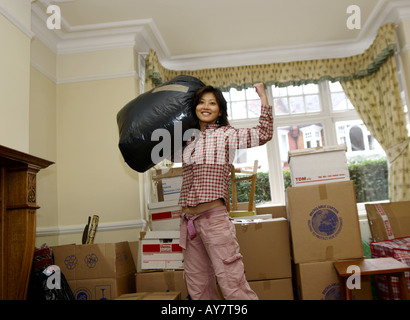 a young woman relaxes happy after move into new home Stock Photo