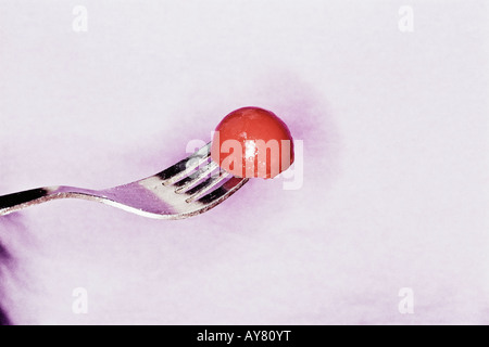 Young Woman Eating Tomato Salad Stock Photo