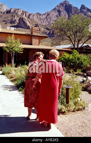 Two senior friends stroll through the desert garden at Dripping Springs la Cueva visitors center, in Las Cruces, New Mexico. Stock Photo