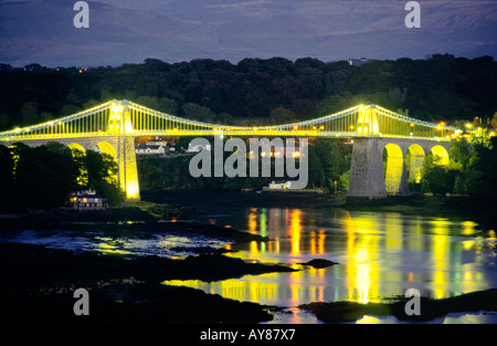 The Menai Suspension Bridge built by Thomas Telford 1826 over the Menai Strait to Anglesey, Gwynedd, north Wales, UK. Floodlit Stock Photo