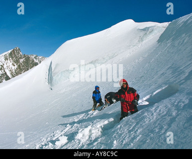 Mountain climbers are building a snow cave for camping The Belukha Mount The Katunskiy Ridge Altai Russia Stock Photo