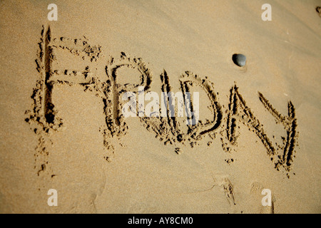 the word friday drawn in the sand tfi Stock Photo