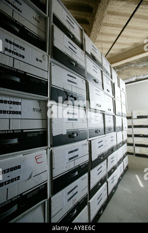 Files of paperwork stored in boxes in office building storage facility Stock Photo