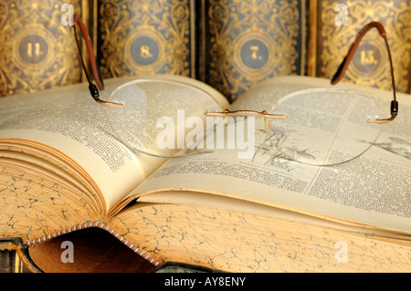 Glasses on the open pages of an old lexicon, Germany Stock Photo