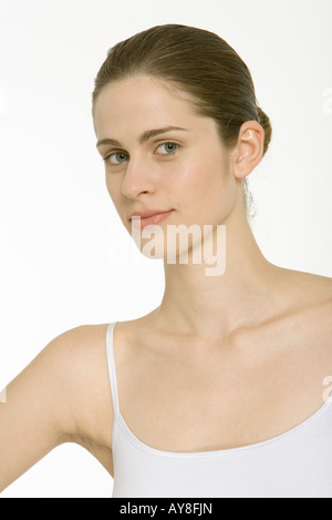 Woman with hair in bun, wearing white tank top, portrait Stock Photo