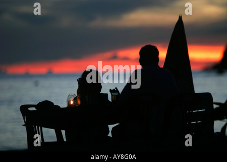 Couple have candle light dinner on beach sunset Pattaya Beach Ko Lipe island Thailand Stock Photo