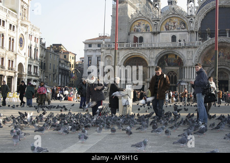 Tourists Feeding Pigeons, San Marco, Venice, Italy Stock Photo