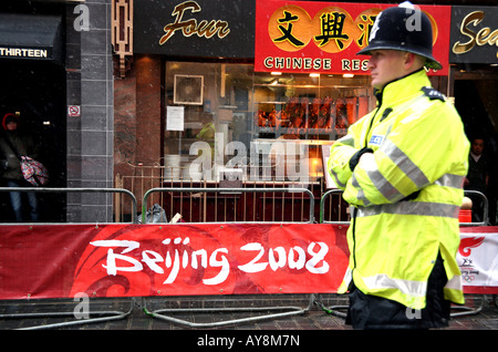 Policeman guards route of Olympic Torch in London Stock Photo