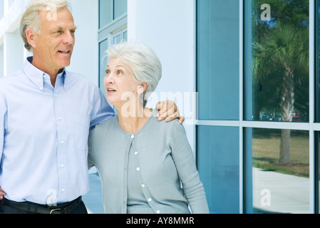 Mature couple walking together, both smiling, close-up Stock Photo