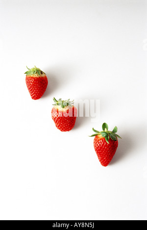 Three strawberries in a diagonal row Stock Photo