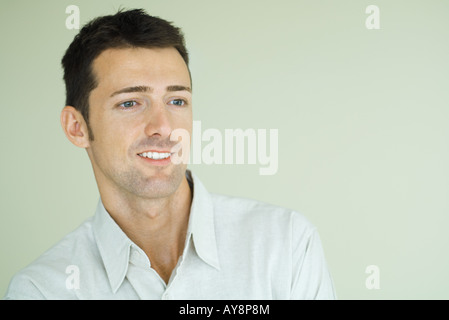 Man smiling, looking out of frame, head and shoulders, portrait Stock Photo