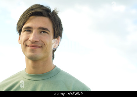 Young man smiling outdoors, portrait Stock Photo