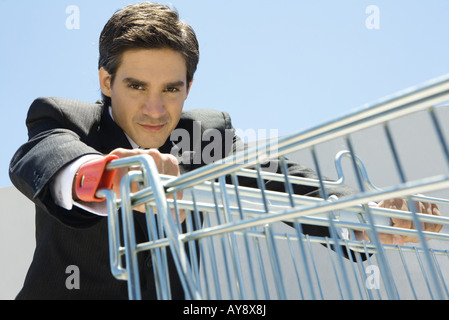 Businessman pushing grocery cart Stock Photo