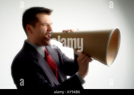 Young business man yelling through a megaphone Stock Photo