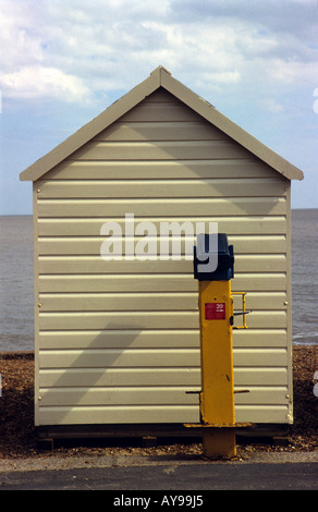 A beach hut placed directly in front of a public coin-operated telescope, Felixstowe, Suffolk, UK. Stock Photo