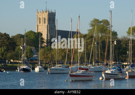 UK Dorset Christchurch Priory church with moored leisure boats Stock Photo