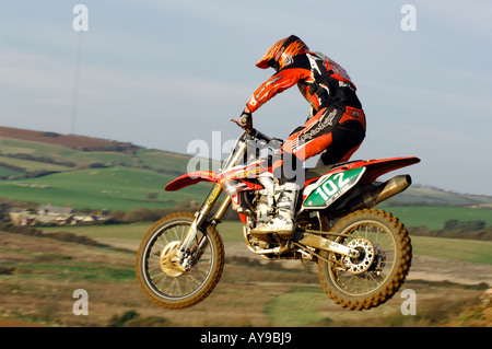 a guy rider on a motocross bile motorcycle jumping and racing big air Stock Photo
