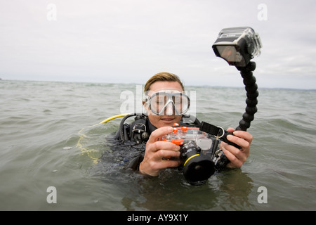 Scuba diver adjusting camera in diving mask Stock Photo