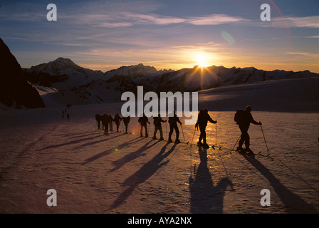 Line of cross country skiers set of at dawn in Selva di Val Gardena, Italy Stock Photo
