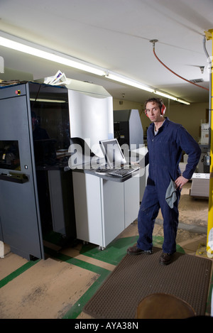 View of a man in coveralls operating a machine by using a computer Stock Photo