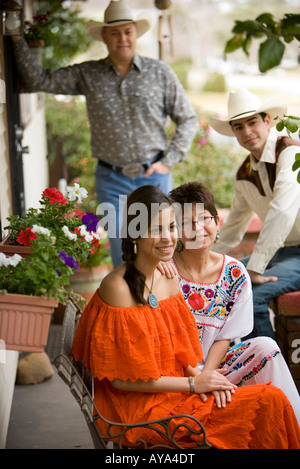 Portrait of a cheerful Tex-Mex family in front porch of house Stock Photo