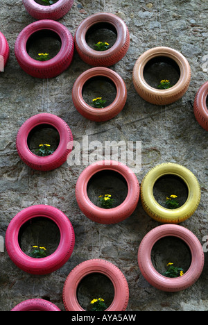 Tyres and flowers hang from the walls at the Girona flower festival 'Temps de flors', held in May each year, Catalonia, Spain Stock Photo