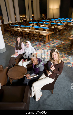 Elevated view of four women students in a sitting lounge in a library Stock Photo