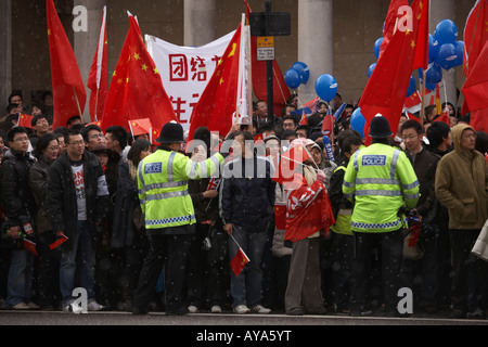 Chinese group welcome the Olympic torch through 31 miles of the London's streets during pro-Tibetan protests Stock Photo