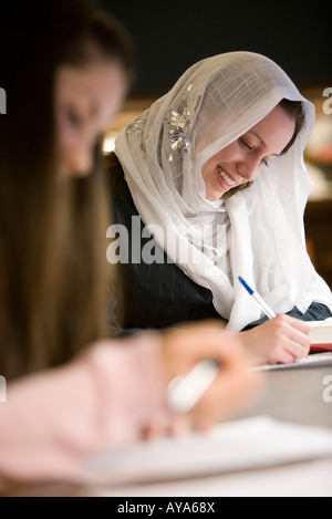 Close up of two women writing Stock Photo