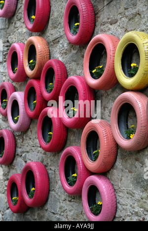 Tyres and flowers hang from the walls at the Girona flower festival 'Temps de flors', held in May each year, Catalonia, Spain Stock Photo