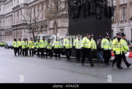 Police officers marching into position during anti-Olympic Games torch demonstration in London, UK Stock Photo