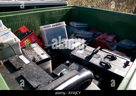 Waste lead acid batteries in a green box at a household recycling centre Stock Photo