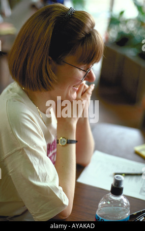 Woman volunteer age 33 helping with Youth Express Bicycle Safety Rodeo. St Paul Minnesota USA Stock Photo