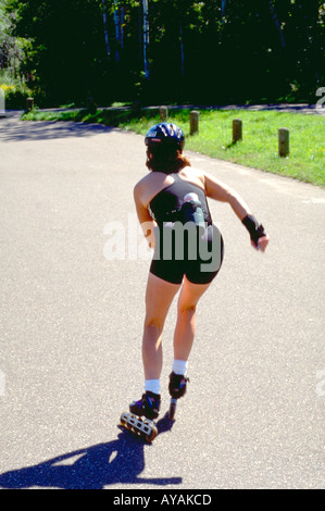 Woman age 27 rollerblading on Gateway Bike Trail. Stillwater Minnesota USA Stock Photo