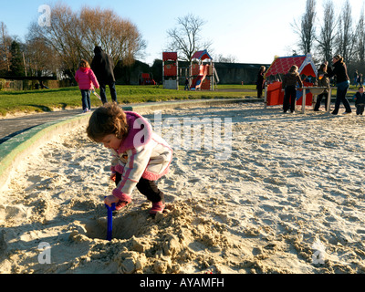 Child Digging Hole In Sandpit Stock Photo