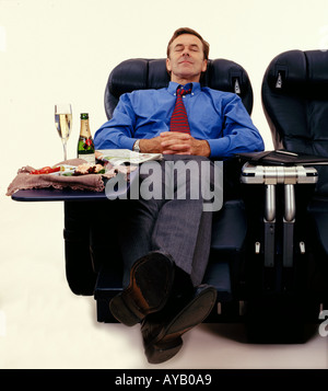Business Executive sleeping sitting in First Class Stock Photo