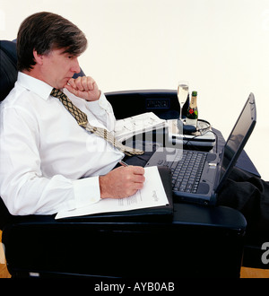 Busnees Executive travelling using laptop Stock Photo