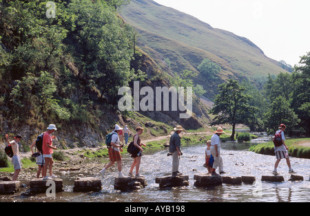 Dovedale Stepping Stones.  People crossing  the  river .  Derbyshire Stock Photo