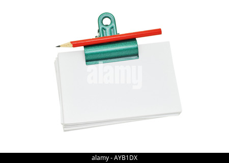 red pencil on bulldog clip holding stack of loose memo papers Stock Photo