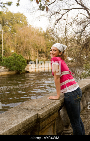 Portrait of a young woman standing by canal Stock Photo
