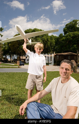 Father and son with a toy glider Stock Photo