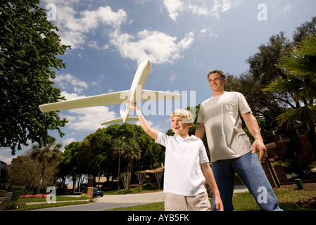 Father and son with a toy glider Stock Photo
